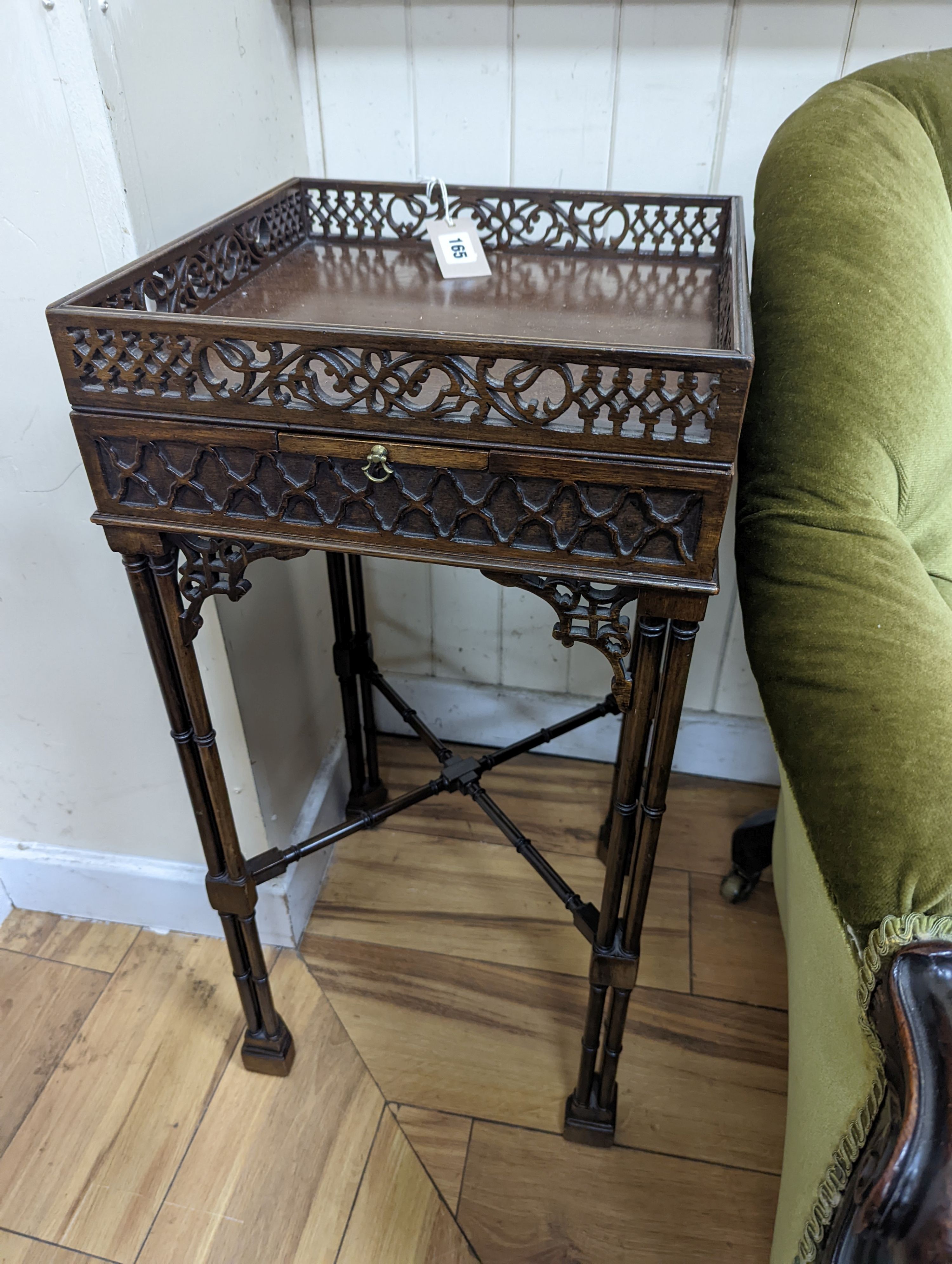 A pair of George III style square mahogany fret cut urn stands on cluster column legs, (one in need of repair) width 34cm, height 72cm